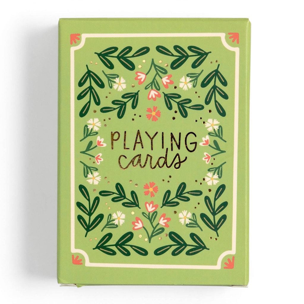 The Green Floral Deck of Playing Cards, shipping in about one week, features a green box with floral patterns and "Playing cards" in artistic lettering—a hand-illustrated design ideal for game enthusiasts.