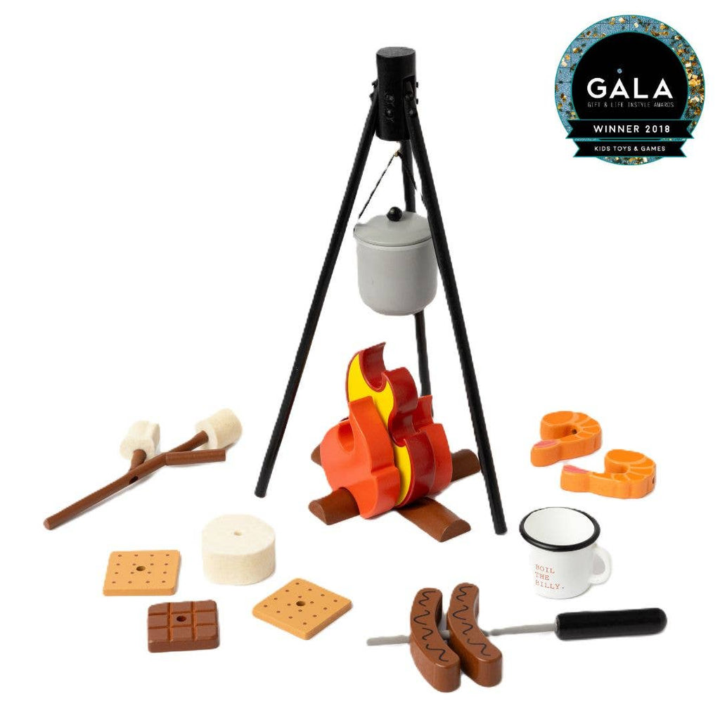 The Wooden Camp Fire Set offers indoor camping fun with a pot over a pretend fire, marshmallows on sticks, sausages, graham crackers, chocolate squares, a mug, and plates. Perfect for kids’ pretend play. GALA Winner 2018 badge shown top right.