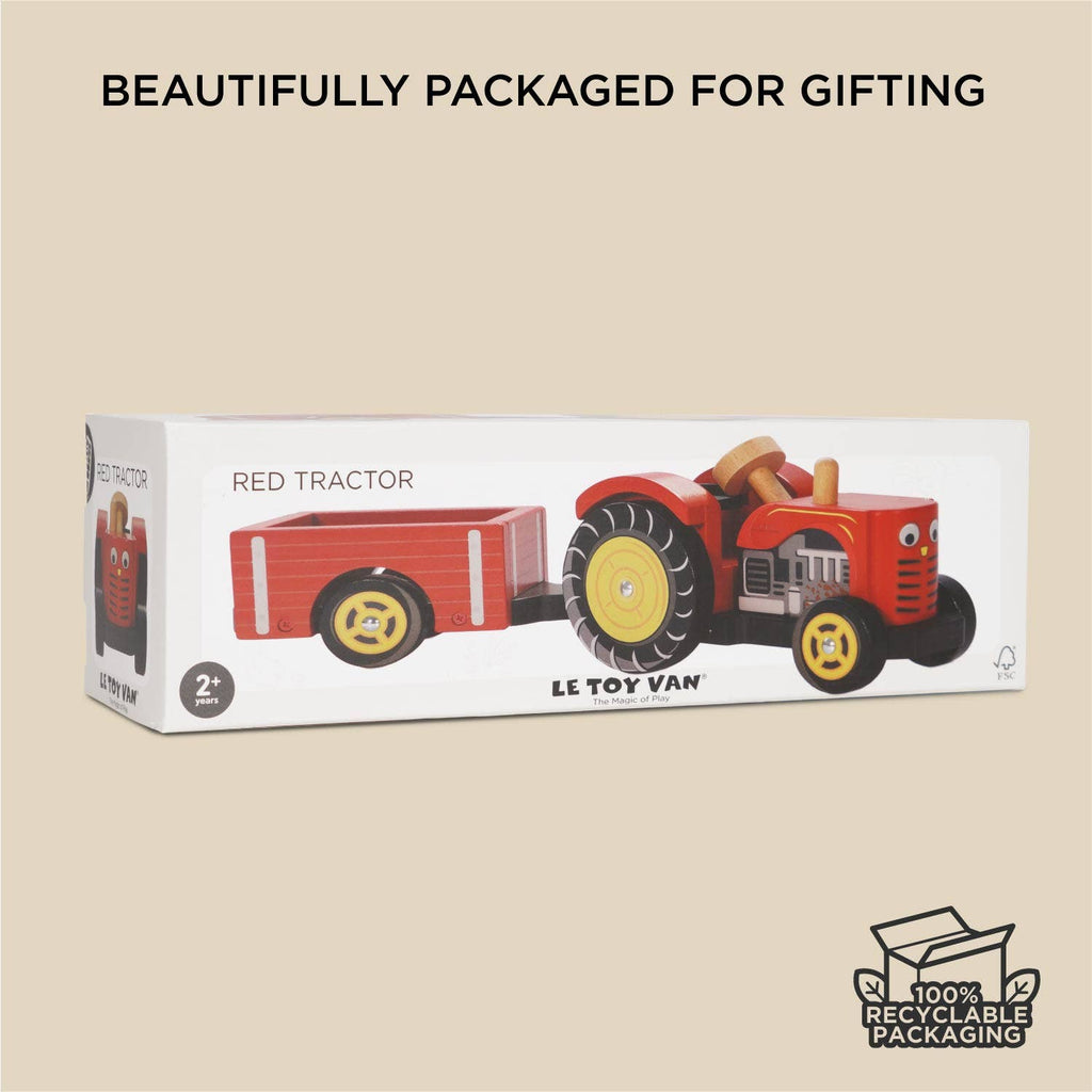 A box labeled "Farmyard Tractor & Trailer" contains a red wooden tractor with a magnetic trailer, plus "LE TOY VAN" branding. Text on the packaging reads "BEAUTIFULLY PACKAGED FOR GIFTING" and "100% RECYCLABLE PACKAGING," with a recycle icon.