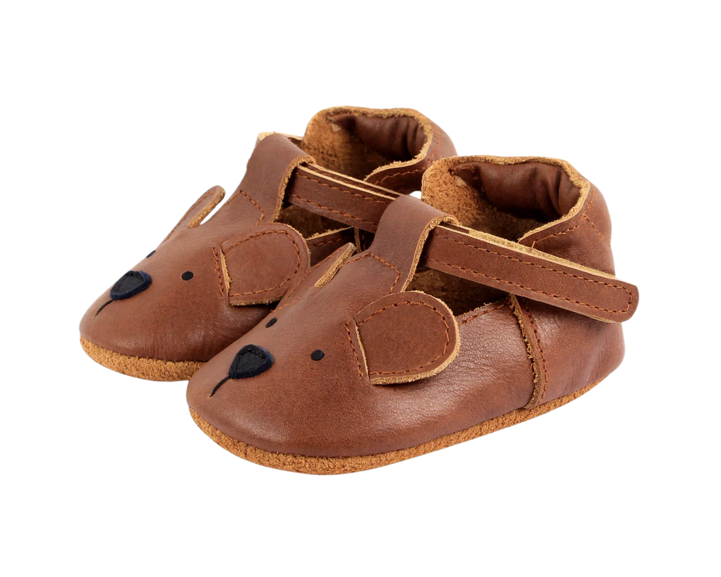 A pair of Donsje Baby Bear Shoes designed to resemble mice, featuring small ears, eyes, and a nose on the toe area, along with a Velcro fastening strap, set against a black