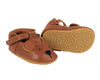 A pair of small brown Donsje Baby Bear Shoes designed to look like bears, featuring bear face details and textured soles.