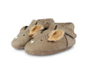 A pair of toddler's beige, animal face-themed slippers with a soft, faux fur interior, displayed on a white background. Product Name: Donsje Leather Spark Exclusive Lined Shoe -Squirrel
