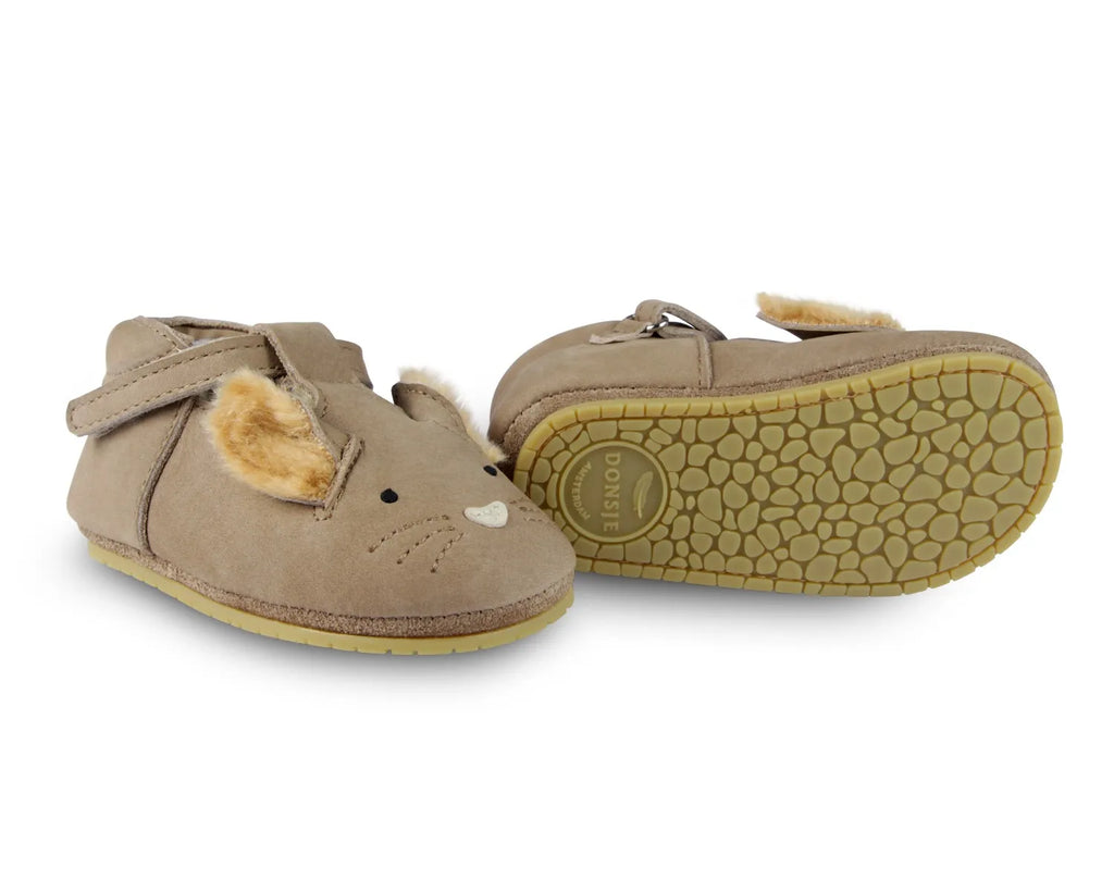 A pair of toddler's light brown moccasin shoes with a squirrel face design, featuring white and tan details, and faux fur textured soles.
