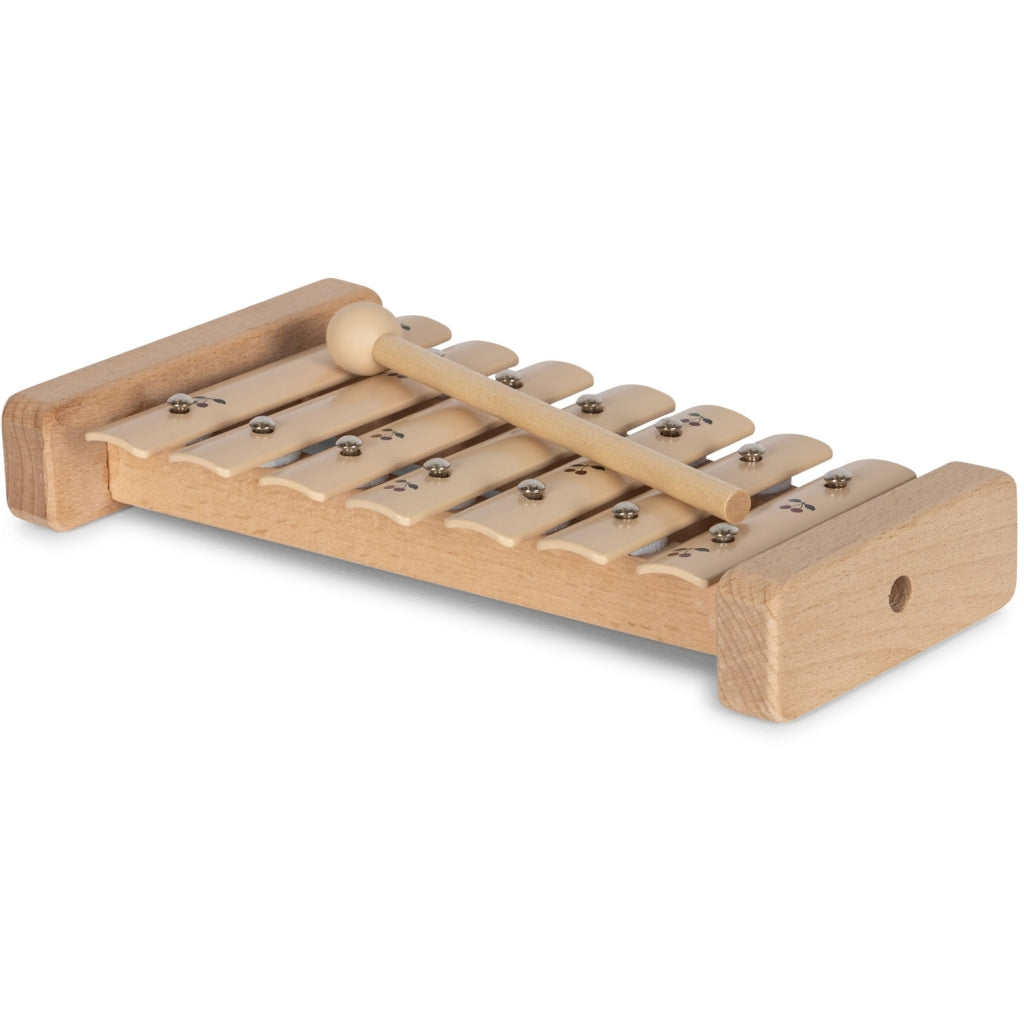 A Wooden Xylophone - Cherry, featuring a paddle with cog-like teeth rotated against a gear to produce sound, isolated on a white background.