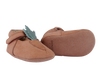 A pair of handmade fairtrade Donsje Baby Carrot Shoes with a Velcro strap and a decorative mint leaf on the side, against a transparent background.