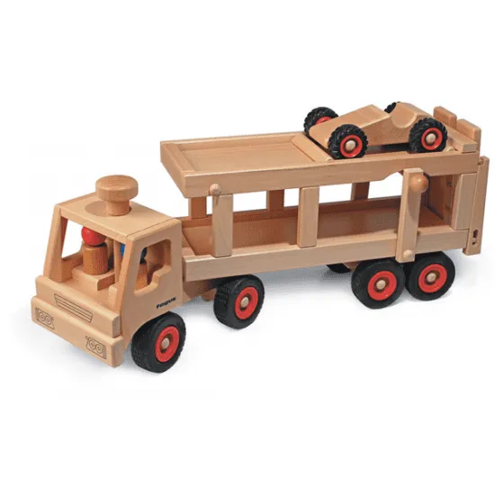 Fagus Car Transporter with a flatbed trailer carrying a smaller speedy car, displayed on a white background. The toys have red and black wheels and crafted details.