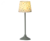 A standing lamp with a patterned shade featuring flowers and leaves in autumnal colors, mounted on a metallic base with a Maileg Farmhouse - Fully Furnished design.