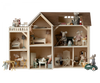 A detailed Maileg Farmhouse dollhouse with various rooms decorated with miniature furniture and small animal figurines engaging in everyday activities, featuring a neutral color palette.