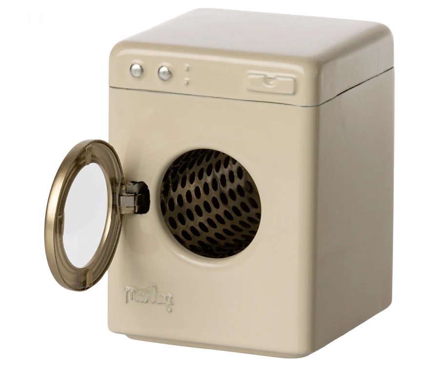 A vintage-looking, cream-colored Maileg Farmhouse - Fully Furnished tabletop washing machine with a round, open door, revealing a dark, textured interior. The device has a simplistic design with a few visible buttons.
