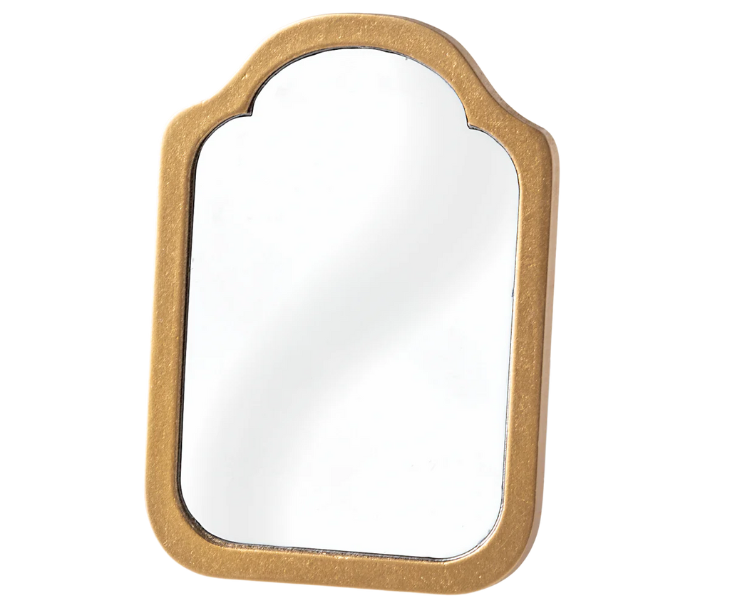 The Maileg Mirror features a golden frame with rounded edges and an arched top, making it perfect for a dollhouse bathroom. Its sleek design complements light-colored settings as it beautifully reflects light.
