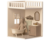 A plush rabbit toy wearing a shower cap sits in a mini bathtub in a Maileg House of Miniature Bonus Room - Bathroom, complete with a sink, mirror, and hanging towel.