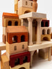 A close-up of a complex structure built from Sabo Concept Italian Ancient City Blocks, featuring detailed columns, arches, and different shades of wood.