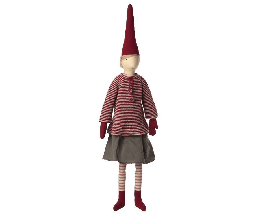 A fabric doll wearing a striped red and white shirt, gray skirt, and striped stockings, with a pointed red hat, standing against a plain background. This exclusive Maileg Christmas Mega Pixy serves as an ideal Christmas