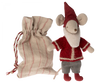 A Maileg Santa Mouse dressed in Santa clothes with a red knitted sweater, gray pants, and a red pointed hat stands next to a beige fabric drawstring bag with red stripes. The toy features large round ears and a long tail, perfect for Christmas night decorations.