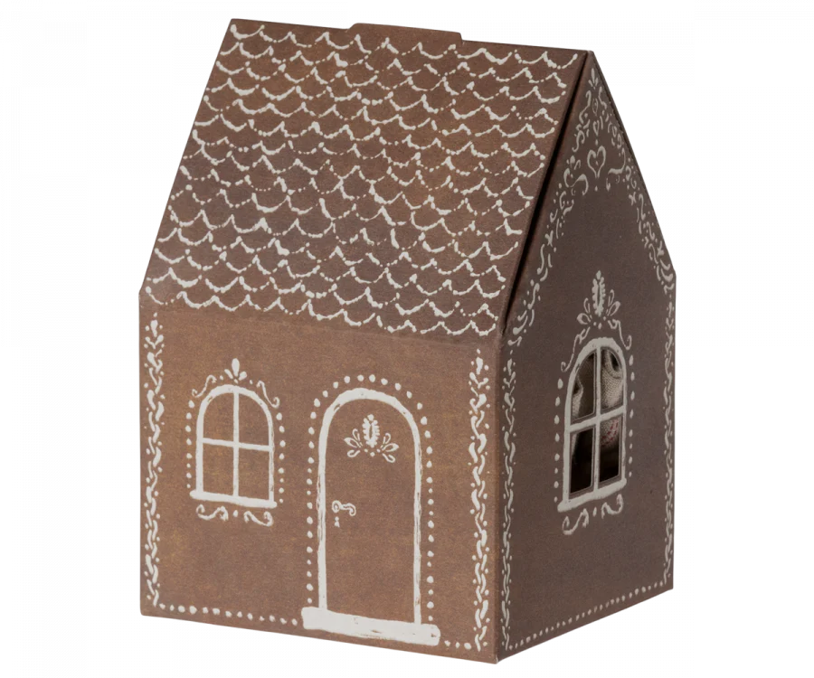 A small, brown paper Maileg Santa Mouse designed to look like a gingerbread house. It features white icing-like decorations, including rooftop details, window frames, and a decorative door. The house has a simple and whimsical design perfect for Christmas night.