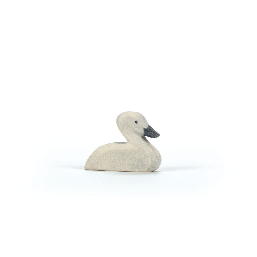 A small, handcrafted Ostheimer Swan figurine with a light body and dark beak is positioned against a plain white background.
