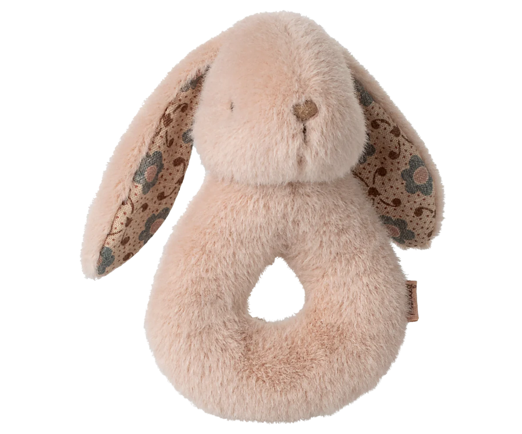 The Maileg Bunny Rattle Set - Powder is a plush baby toy made from soft cotton, shaped like a beige bunny with floral-patterned inner ears. Its looped bottom allows for easy gripping by small hands, making it a perfect gift set addition.