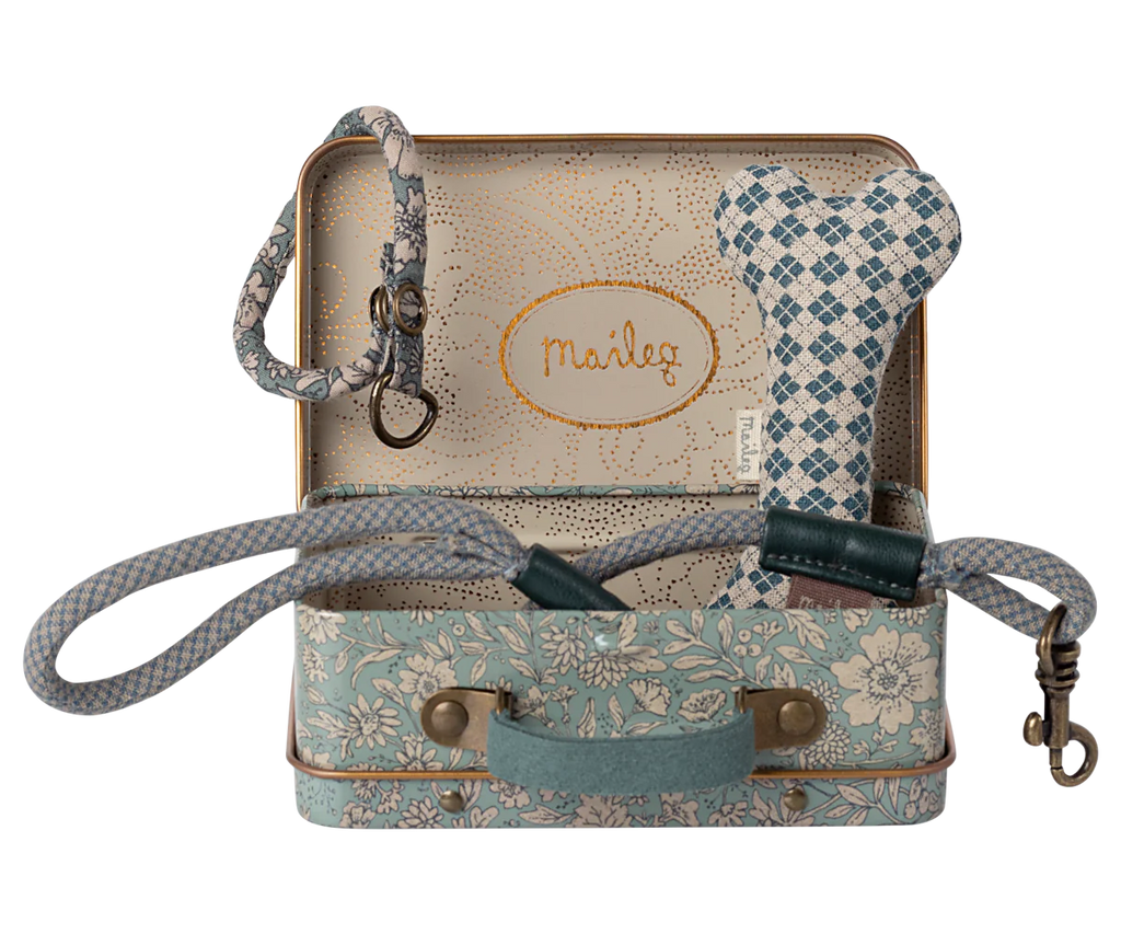 The Maileg Puppy Supply Accessories - Blue set includes a small metal suitcase with Maileg print, a plush dog leash, blue and white checkered heart toy, floral collar with clasp, and "Maileg" cursive interior.
