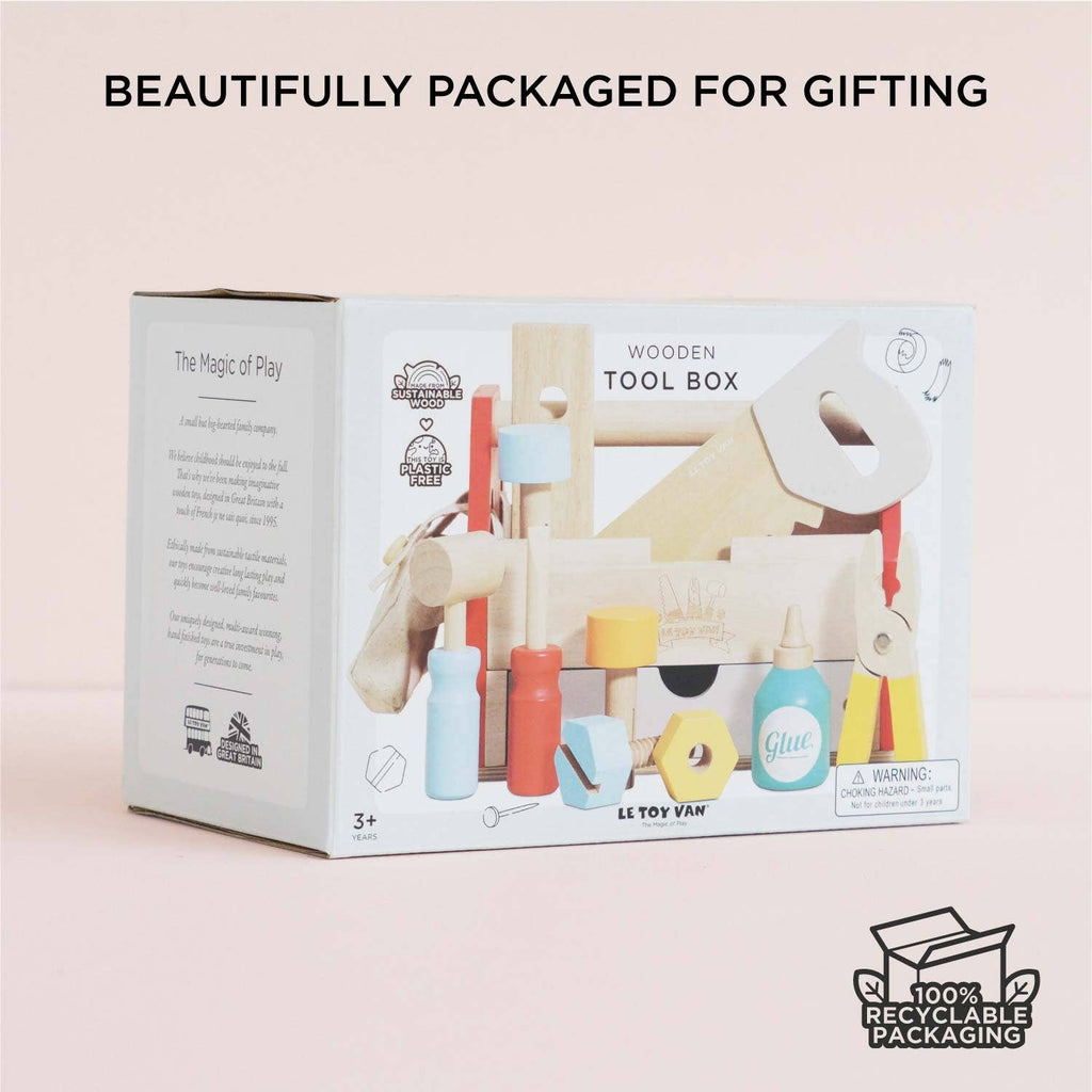 A box labeled "Tool Box & Wooden Tools" with toy tools is displayed against a light background. Text reads "Beautifully Packaged for Gifting." The set builds fine motor skills and comes in 100% recyclable packaging.