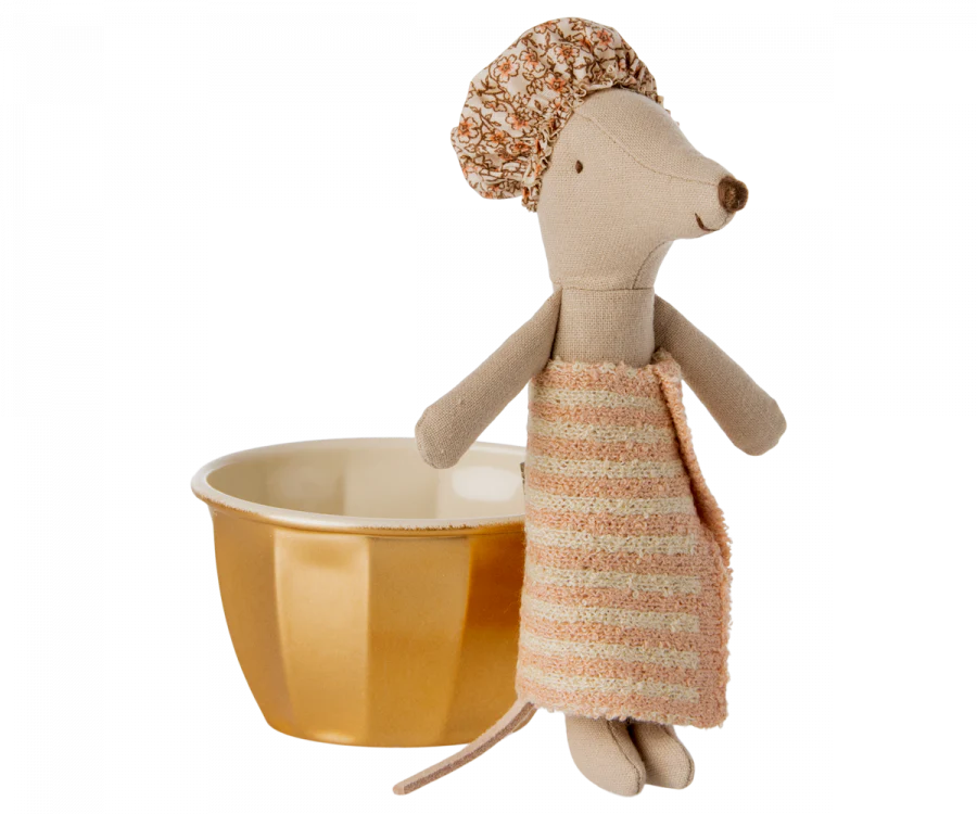 A Maileg Spa Starter Set fabric stuffed mouse toy with a textured beige and multicolored outfit, standing beside a small yellow bowl, isolated on a black background.