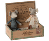Two Maileg Grandma & Grandpa Mice in Cigarbox, one dressed in a floral dress and the other in a plaid shirt, sitting in an open cigar box labeled "Havana cigars," now repurposed with cozy bedding.