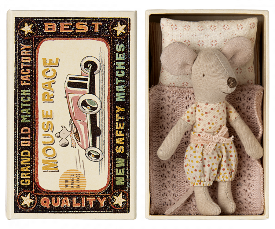 An image of a Maileg Little Sister mouse in matchbox made of fabric, wearing a floral dress, placed inside a small matchbox bed featuring vintage-style graphics with text "best mouse race" and "grand old match".