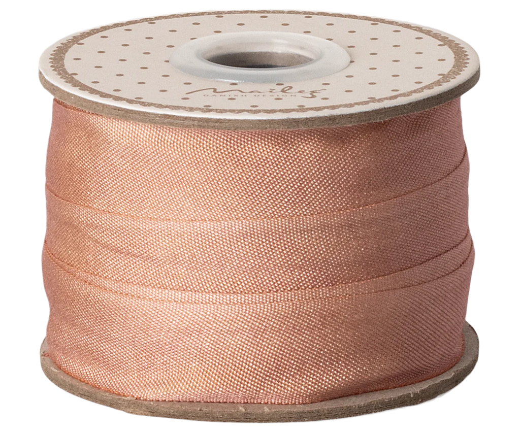 The Maileg Ribbon - Peach Rose (10m) features a light peach satin finish with a cardboard core and polka-dotted top, adding an exclusive touch to any gift wrap.