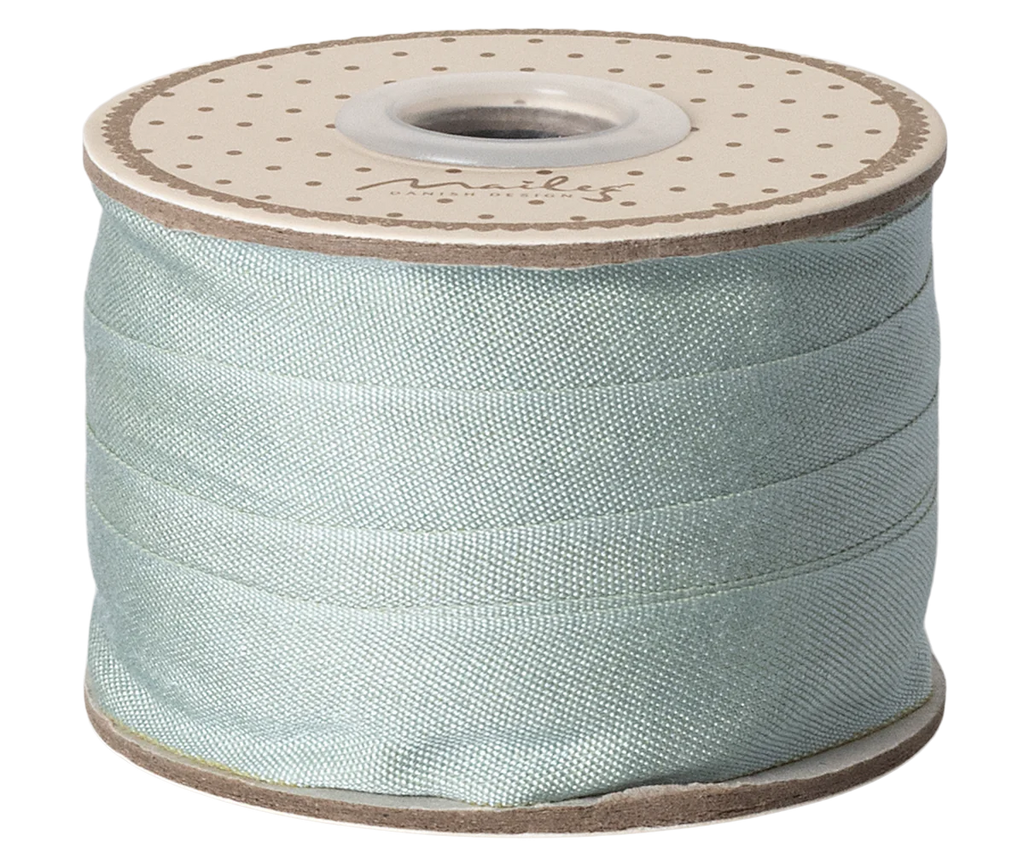 Maileg Ribbon - Dusty Mint (10m) is a light blue decorative ribbon on a polka-dotted reel, perfect for gift wrapping and giving any present an exclusive touch.
