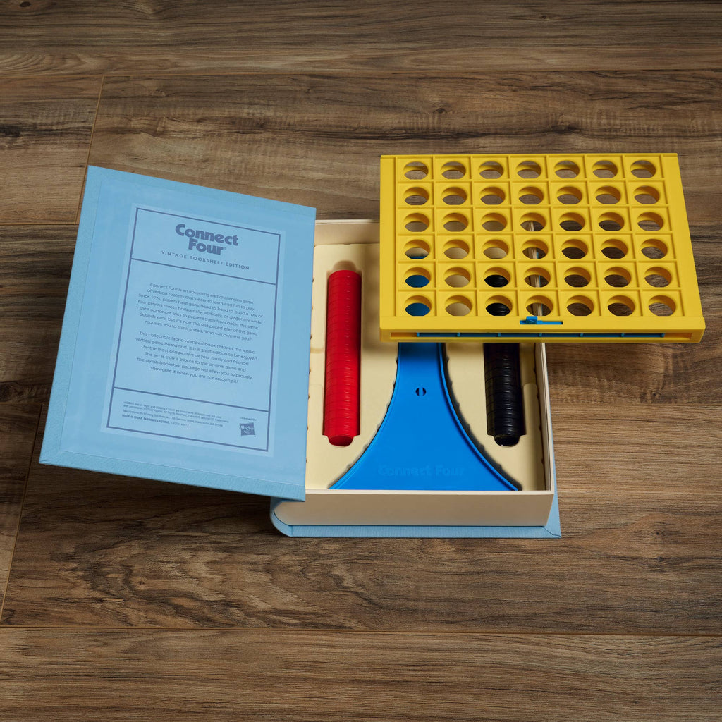 The Board Game: Connect 4 Vintage Bookshelf Edition comes in a book-shaped box with a yellow grid, blue stand, red and black discs, and instructions inside the lid for this classic vertical strategy game. Perfect for collectors and vintage game lovers.