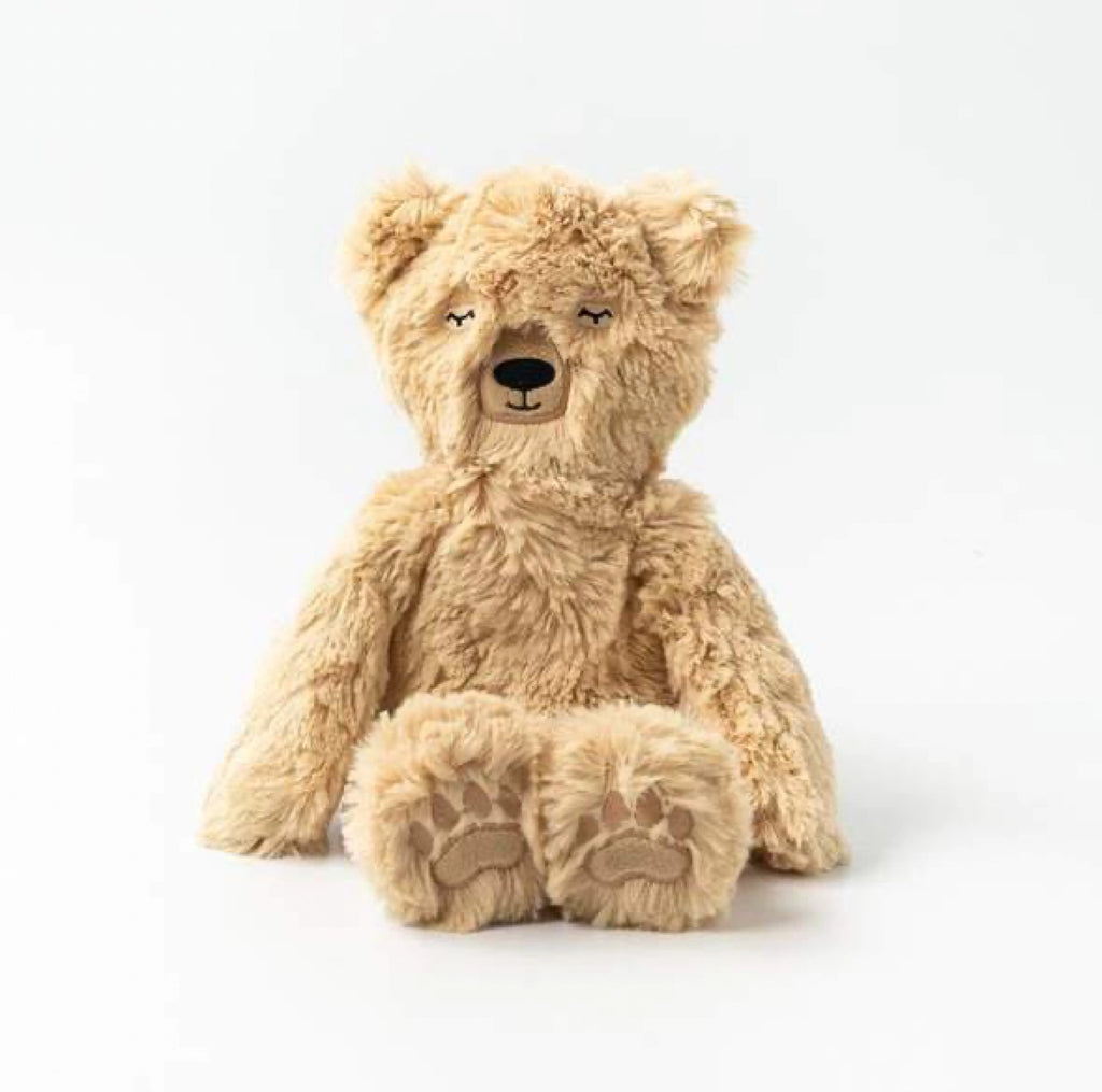 A Slumberkins Honey Bear Kin plush teddy with soft tan fur, sitting against a plain white background, featuring stitched eyes and a subtle smile.