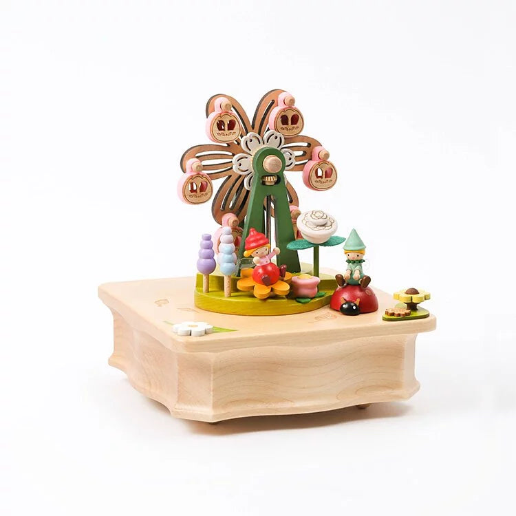 A colorful Ferris Wheel Fairy Music Box featuring a whimsical floral and forest design, with small figures like trees and mushrooms, crafted from sustainably sourced wood and set on a light wooden base.