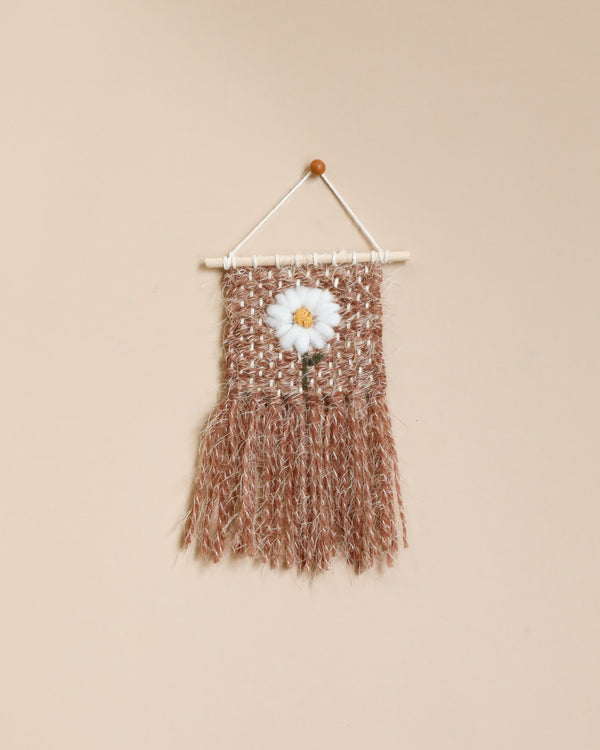 A Handmade Mini Flower Wall Hanging featuring a white flower in the center, displayed on a plain beige background.