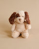 A Steiff Peppi Puppy Dog, 11 Inches plush toy with brown ears and a cream-colored body sits facing the camera against a plain light beige background.