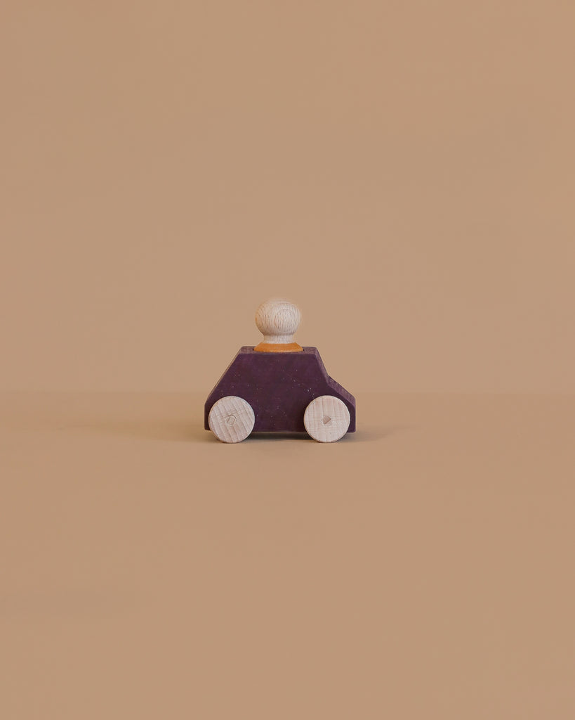 The Lubulona Wooden Car with Figure - Plum features a purple body, light wooden wheels, and a round peg figure—a charming minimalist toy ideal for anyone looking for eco-friendly kids toys.