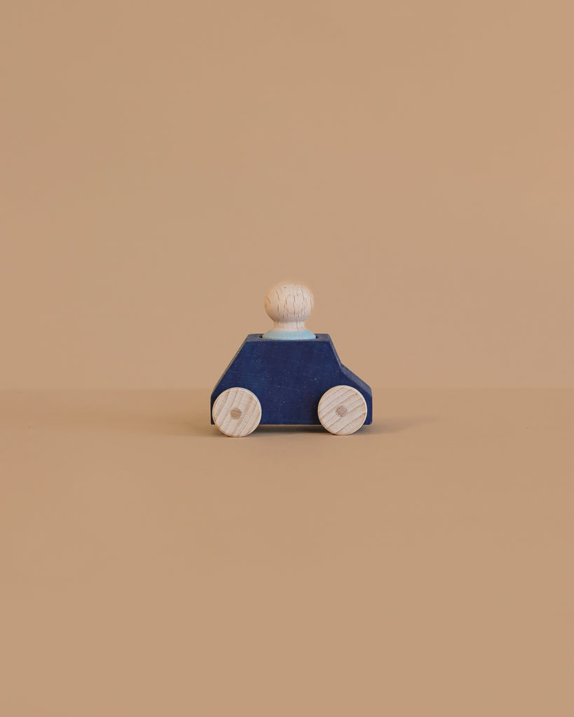 A Lubulona Wooden Car with Figure - Blue features a simple wooden toy figure and eco-friendly car with natural wheels, set against a plain beige background.