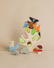 A colorful wooden Stacking Forest puzzle for children, featuring assorted colored animal and nature-themed pieces against a plain beige background.