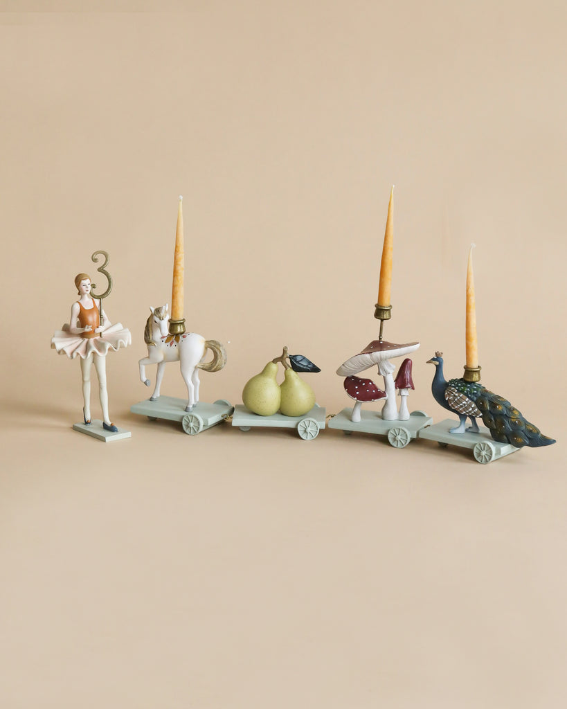 polyresin train of animals and figurines holding candles and numbers