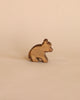 A Ostheimer Small Bear - Sitting on a plain beige background, with visible wood grain and a simplistic, stylized design.