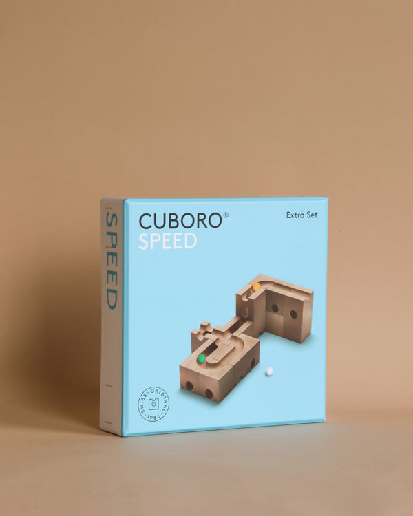 A Cuboro Speed Marble Run Extra Set - Speed box on a beige background, featuring an image of wooden tracks and a marble run on its cover.