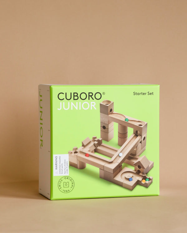 A Cuboro Junior Marble Run Starter Set, consisting of wooden blocks and tracks designed for constructing marble runs, displayed against a beige background.