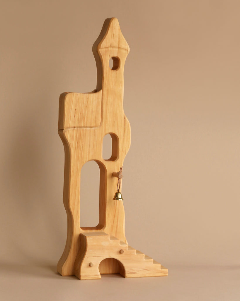 The Ostheimer Fairytale Tower with Maileg Romeo and Juliet Set features a whimsical wooden tower with arched openings, a small staircase, and a tiny brass bell—perfectly showcased against a plain light brown background.