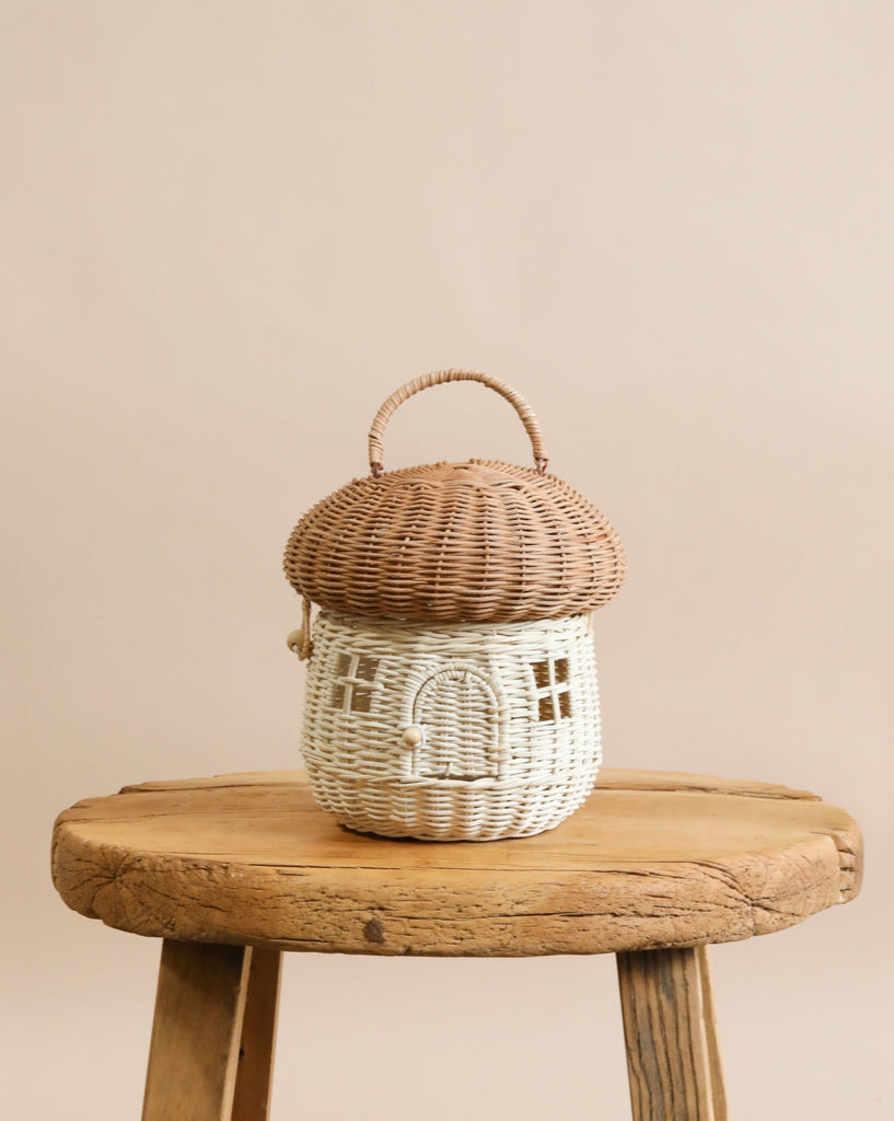 A natural color rattan mushroom basket on a chair.