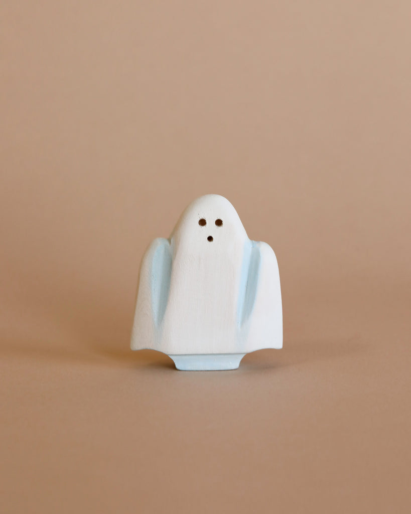 A charming Bumbu Handmade Wooden Haunted Pumpkin Cottage Set is displayed on a plain beige background, ideal for Halloween-themed toy setups or Montessori imaginative play.