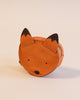 A Donsje Mini Leather Backpack - Fox designed to resemble a fox's face, featuring pointed ears and minimalistic facial features on a plain background, crafted in a Donsje design.