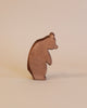 A Ostheimer Large Bear - Standing Head Low figurine, standing upright with an angled profile and smooth edges, set against a soft beige background.