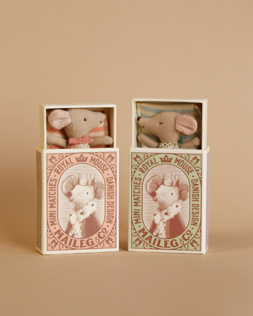two small boxes each with a mouse doll inside.