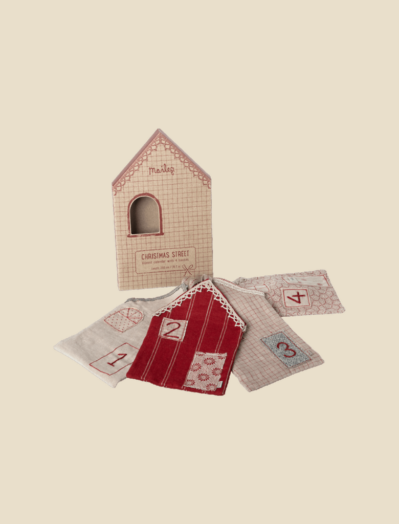 Four small, numbered fabric pouches and a house-shaped box labeled "Maileg Christmas Street, Advent Calendar" are displayed on a light background, perfect for use as an advent calendar or festive Christmas decoration.