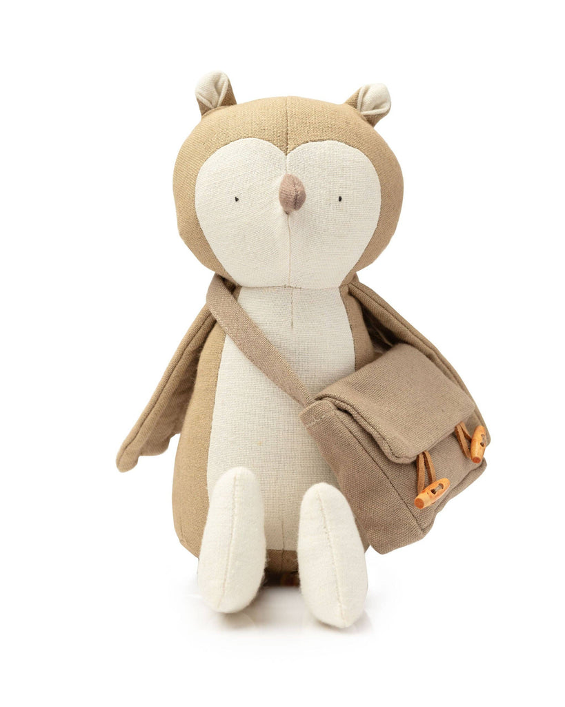 Owen The Owl is a plush toy with a light brown body, white face and belly, simple stitched eyes, and a tiny beak. He wears a small brown messenger bag with buttons, embodying the charm of a woodland-themed adventure.
