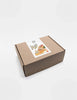 A closed rectangular brown cardboard box with a decorative shipping label featuring colorful illustrations of plants and Sabo Concept Italian Courtyard Blocks, viewed against a plain white background.
