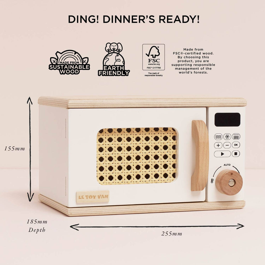 The Wooden Microwave (ships in one week) features a white and natural wood finish, digital control panel, and rattan-style door. Made from sustainable wood—perfect for any play kitchen. "Ding! Dinner's Ready!" appears at the top.